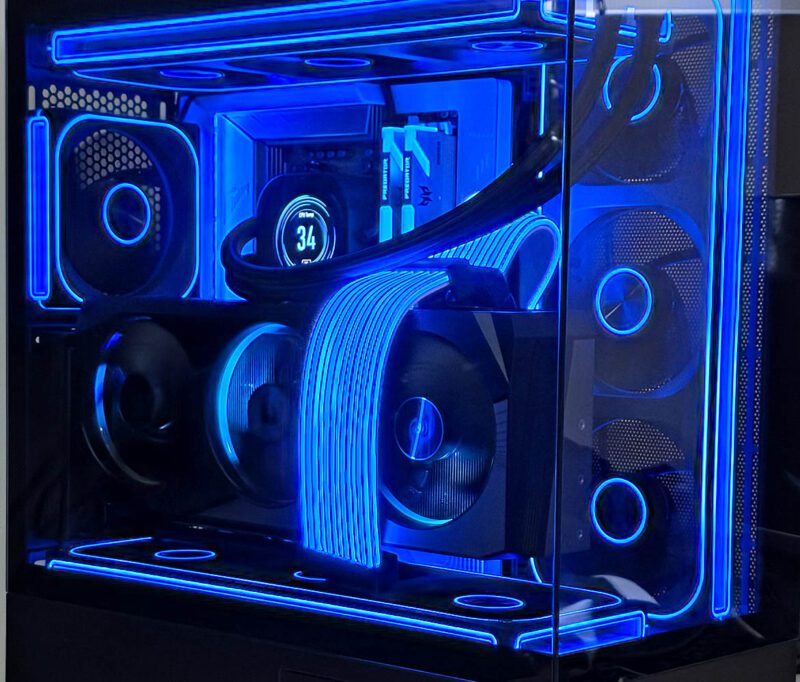 Customer-supplied 7900 XTX gaming PC build with vertical GPU mount and blue RGB lighting at Your Geek Friend Computers in Gloucester